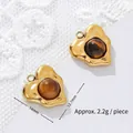 Detail view of 18K gold-plated tiger eye heart pendants showing 14mm and 12.7mm measurements - Irregular Heart