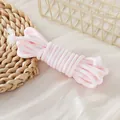 Close-up of 5mm light pink braided paracord rope for DIY lanyards and phone chains - 1 Meter (Trial Version) / White & Pink Houndstooth