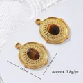 Detailed view of oval tiger eye stone pendant with gold plated stainless steel frame - Dotted Oval Disc