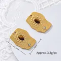 Close-up of tiger eye stone pendant with measurements 24.5mm by 18mm and weight info. - Rhinestone Irregular Disc