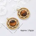 Detail view of 18K gold plated stainless steel tiger's eye pendant with size markings - Hollow Carved Round