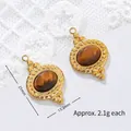 Detail view of 18K gold plated tiger's eye steel pendant with 21x13.2mm dimensions - Rope Pattern Oval