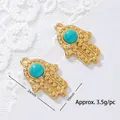 Close-up of golden Hamsa hand pendant with turquoise stone and size dimensions - Dotted Hamsa Hand