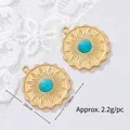 Detailed view of sun-shaped 18K gold plated stainless steel pendants with turquoise centers - Lace Sun Round Plate Style