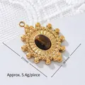 Detailed macro view of tiger eye stone pendant with 18K gold plated stainless steel sunburst. - Beaded Border Oval