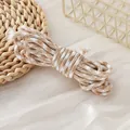 Detailed close-up showing the texture of 5mm houndstooth pattern polyester braided cord. - Light Brown & White Houndstooth