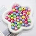 Close-up of colorful UV printed acrylic beads with iridescent finish and heart patterns - Multicolor