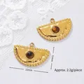 Macro view of 18K gold-plated stainless steel pendants with round tiger eye stones - Beaded Edge Fan-shaped