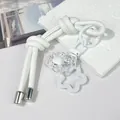 Detailed macro view of white leather rope keychain with clear flower and star charm - Double Knot / White
