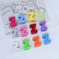 Macro detail of colorful 6mm acrylic alphabet Z beads for DIY keychain and phone straps. - Letter Z / 6mm Aperture / Purple