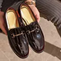Premium burgundy patent leather men's loafers featuring a classic gold horsebit buckle - 40 / Gradient Red