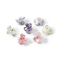 Detailed close-up of iridescent pearlescent cherry blossom pendants for DIY jewelry crafts - Random Mix (4656)