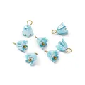 Close-up of elegant blue pearlescent lily flower charms with gold loops for DIY jewelry - Iridescent Lake Blue (4661#)
