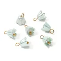 Detailed macro shot of pearlescent mint green lily flower charms with golden jump rings - Green (4661)