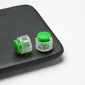 Close-up of green and clear double-hole plastic cord locks for masks and drawstrings - Double Hole Spring Adjustment Buckle / 10 Pieces Pack / Semi-transparent Green