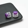Close-up detail of purple plastic spring cord lock with clear housing and internal spring - Double Hole Spring Adjustment Buckle / 10 Pieces Pack / Semi-transparent Purple