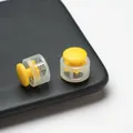Close-up detail of durable yellow and transparent plastic spring toggle stoppers - Double Hole Spring Adjustment Buckle / 10 Pieces Pack / Semi-transparent Yellow