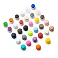 Overhead shot of colorful double-hole plastic cord locks in various vibrant colors - Double Hole Spring Adjustment Buckle / 10 Pieces Pack / Mixed Random
