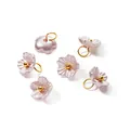 Detailed view of six pearlescent ABS flower charms with gold loops for DIY jewelry - Champagne (4664)