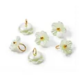 Detailed view of iridescent pearl flower pendants with gold jump rings for DIY crafts - Green