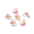 Macro detail of iridescent pearlescent ABS flower charms with golden jump rings - Pink