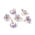Macro view of iridescent purple pearl flower pendants with gold rings for DIY jewelry - Purple