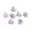 Close-up detail of iridescent pearlescent ABS flower charms with golden hanging rings - Pearly Blue-Purple