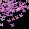 Detailed macro shot of purple frosted acrylic flower beads with gold foil splatter on black. - Gold Foil Four-Petal Flower Cap / 100 Pieces/Pack / Purple