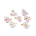 Detailed macro view of ABS pearlescent flower pendants with gold-colored metal jump rings - Pearlescent Pink Purple