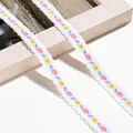 Nahaufnahme von weißem besticktem Spitzenband mit bunten Blumenmustern und Wellenkante - 1m / Weiß Rosa Gelb