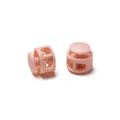 Close-up macro view of pink round double-hole plastic cord locks with internal spring - Double Hole Spring Adjustment Buckle / 10 Pieces Pack / Solid Peach Pink