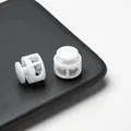 Close-up detail of durable white double-hole plastic spring cord locks for face masks - Double Hole Spring Adjustment Buckle / 10 Pieces Pack / Solid White