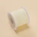 Vue détaillée d'une bobine de fil de jade jaune pâle de 0,6 mm pour bijoux DIY - 10m/Paquet env. 6.5g / Blanc Cassé