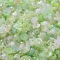 Close-up of mixed light green and white acrylic beads with flower and star shapes - (5-15mm) 20 Grams / Light Green Series