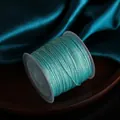 0.8mm turquoise chameleon polyester cord with metallic shimmer on clear spool - Light Blue
