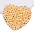 Perle Dundun in vetro arancione chiaro per gioielli fai-da-te in un piatto a forma di cuore. - Arancione Chiaro