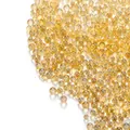 Macro close-up of iridescent amber glass bubble beads for DIY jewelry and nail art accessories - Orange Yellow