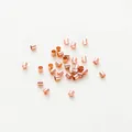 Close-up of rose gold plated metal crimp tubes for DIY jewelry making accessories - 1.5mm Positioning Tube (Pack of 100) (GA0067) / Rose Gold Plated