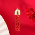 Festive golden bell charm with red tag engraved with Chinese characters - Good Luck