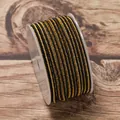 Macro detail of 2.5mm black and gold braided non-elastic cord on a plastic spool for DIY jewelry. - Yellow Black
