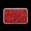 Close-up macro detail of irregular bright red crushed glass stones for nail art DIY crafts - Red