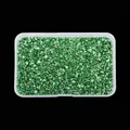 Detailed view of irregular emerald green high-bright crushed glass stones in a box - Green