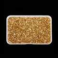 High-angle macro view of irregular golden metallic crushed glass stones for DIY crafts - Gold