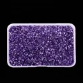 Detailed view of high-gloss purple crushed glass stones in a plastic box - Bright Purple
