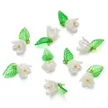 Macro shot of white acrylic lily-of-the-valley charms with green leaves for DIY crafts - Transparent Blue (Style 08)