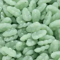 Macro view of green imitation jade glass beads in a leaf shape for DIY jewelry making. - 10 Pieces (11x18.5mm)