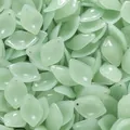 Close-up view of light green jade-like glass leaf pendants for DIY jewelry making - 10 Pieces (13x19mm)