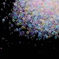 Close-up view of iridescent transparent bubble glass beads for DIY nail art designs. - 10g/Pack / Macarons