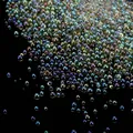 Macro view showing the iridescent shimmer of transparent no-hole glass bubble beads for nail art - 10g/Pack / Grey Green