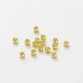 Close-up of small 14K gold-plated spacer beads for DIY jewelry making accessories. - 1.5mm (100 Pieces/Pack) / 14K Gold